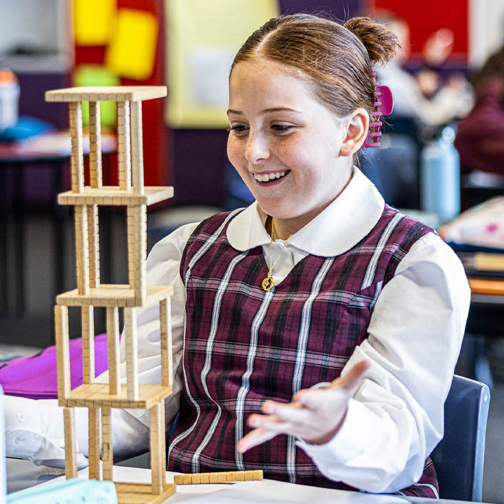 Student playing with maths equipment at Christ the King Catholic Primary School North Rocks