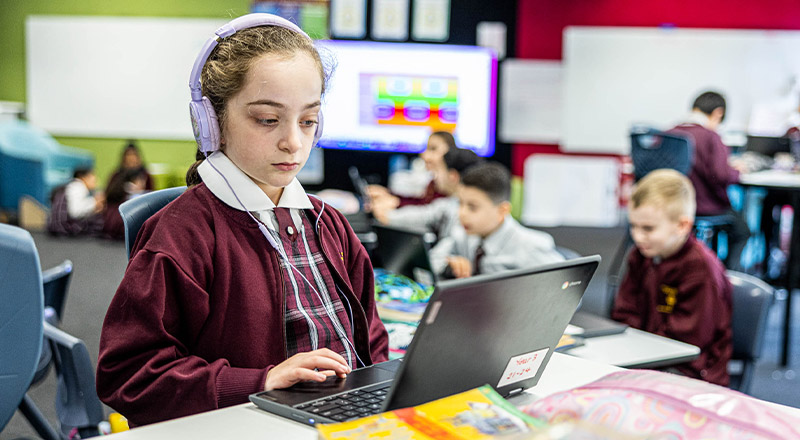 Student with headphones in at Christ the King Catholic Primary School North Rocks