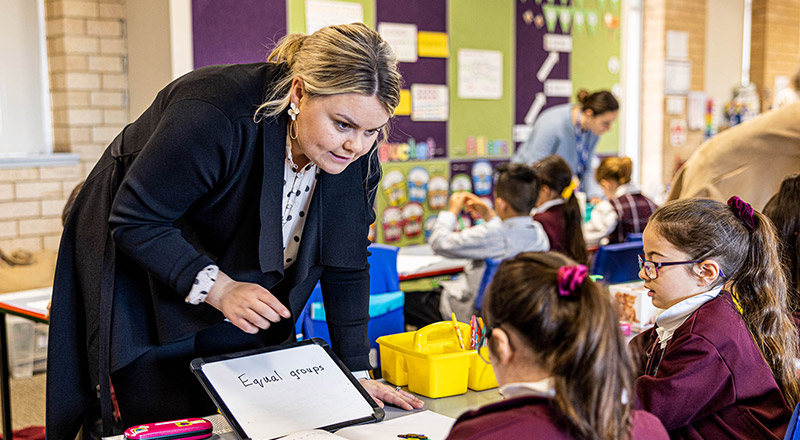 Teacher assisting student at Christ the King Catholic Primary School North Rocks