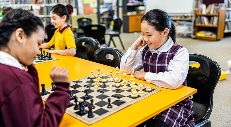 Student playing with chess at Christ the King Catholic Primary School North Rocks
