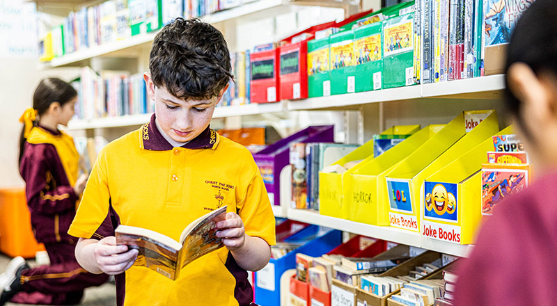 Student holding book at Christ the King Catholic Primary School North Rocks