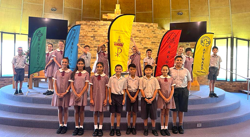 Students standing and holding school banners at Christ the King Catholic Primary School North Rocks
