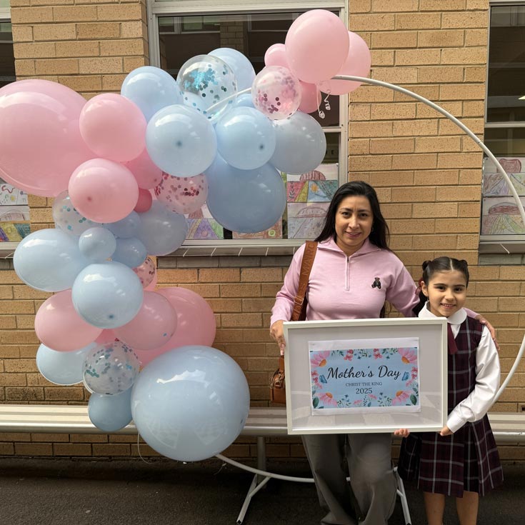 Christ the King North Rocks mother and daughter holding a sign that reads Mother's Day Christ the King 2025